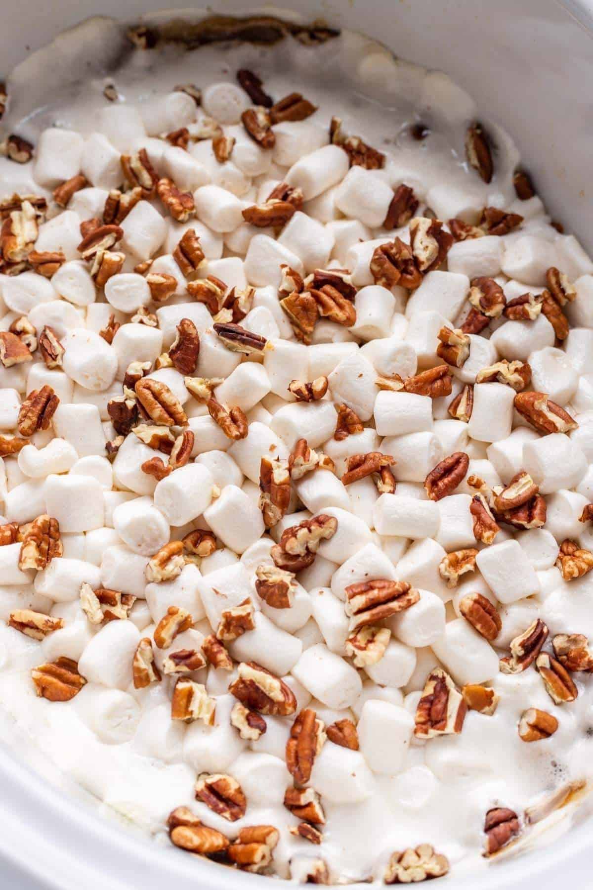Final sweet potato casserole with gooey marshmallows and chopped pecans.