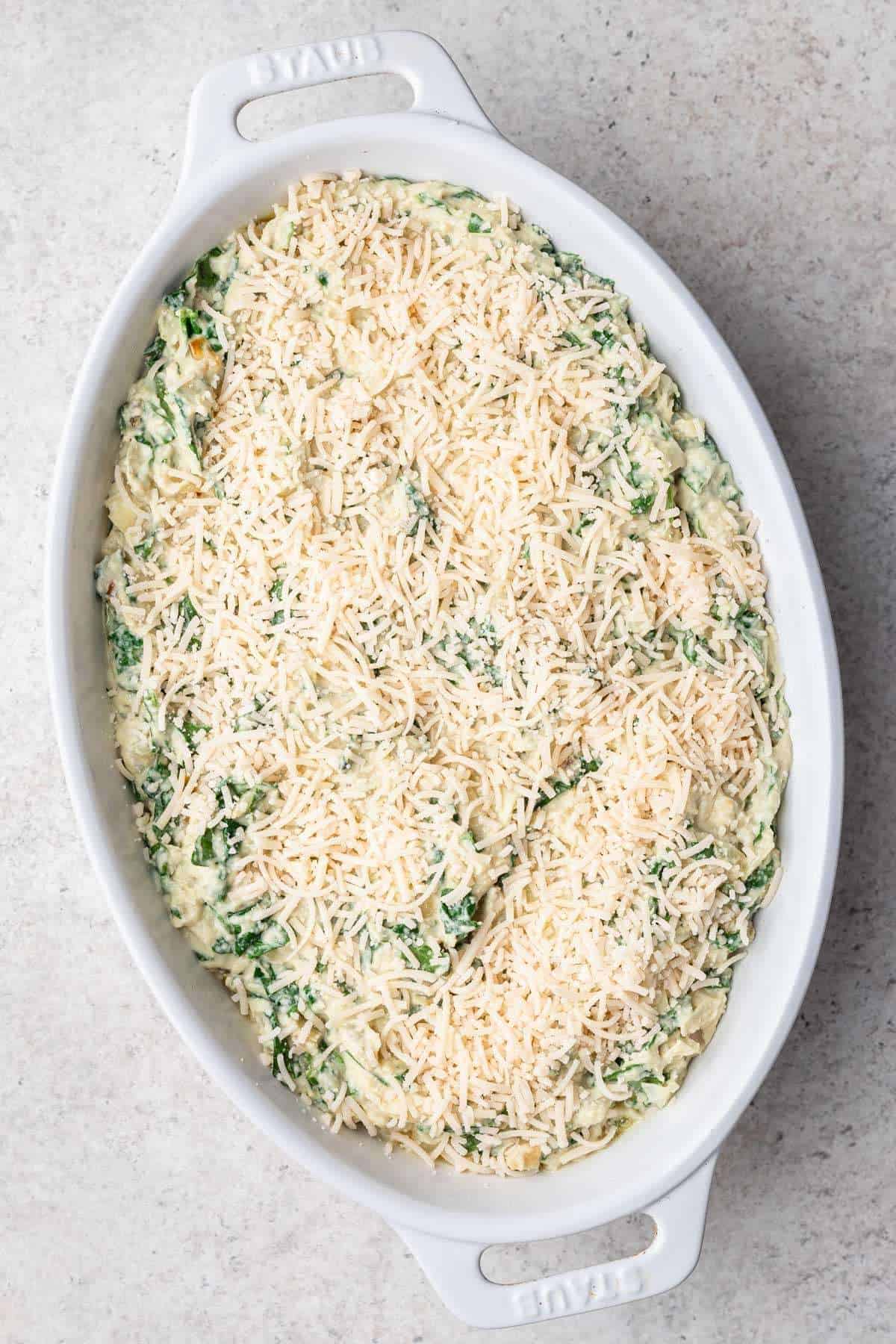 Dip transferred to baking dish and sprinkled with plant-based cheese.