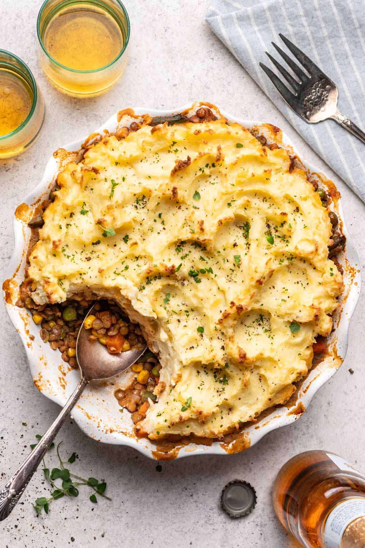 Pie dish with baked shepherd's pie and a scoop taken out for serving.