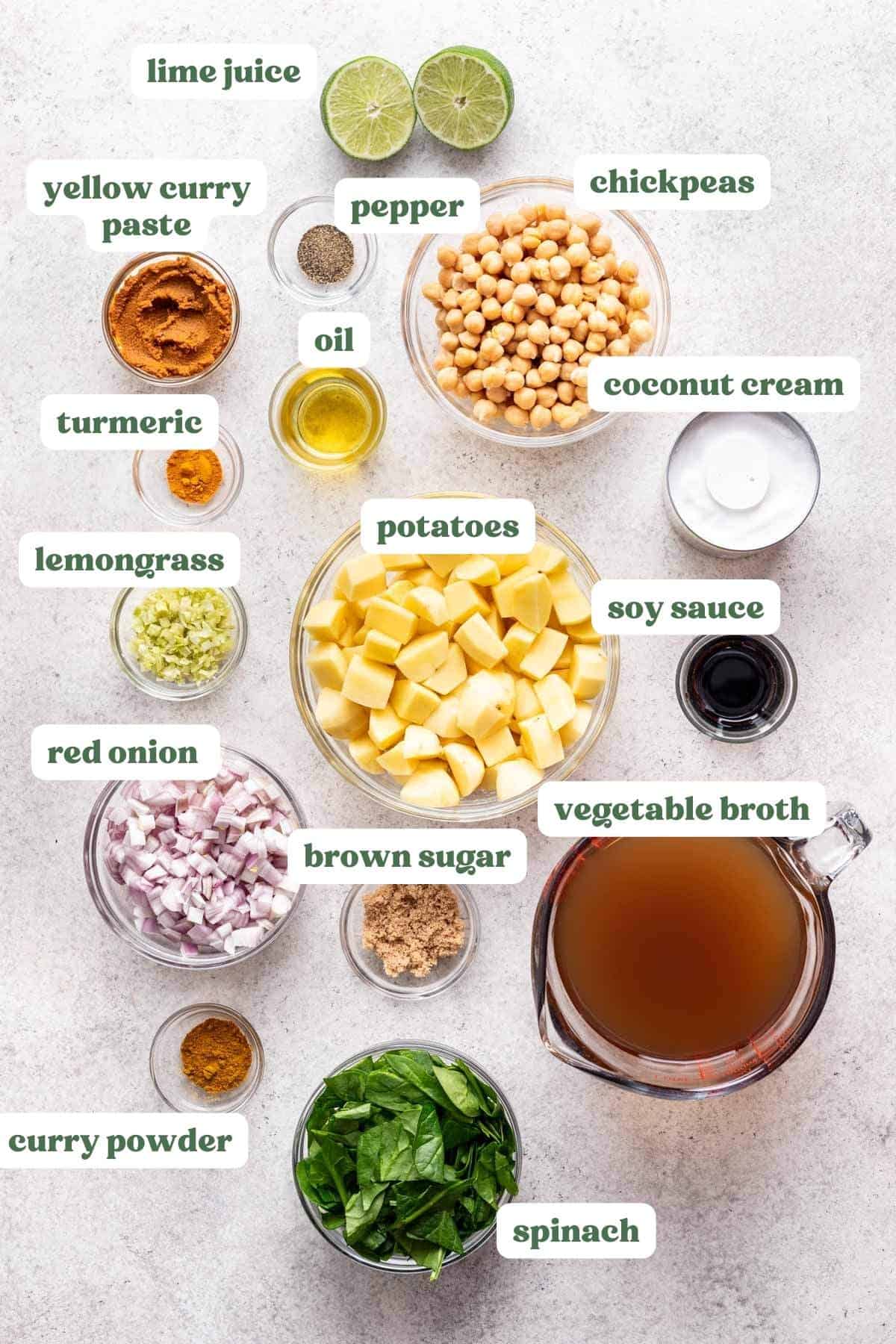 Ingredients needed for yellow curry measured and labeled in individual bowls.